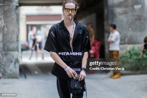 Guest wearing a black shirt and pants, glasses outside Boris Bidjan Saberi during Paris Fashion Week - Menswear Spring/Summer 2018 on June 22, 2017...