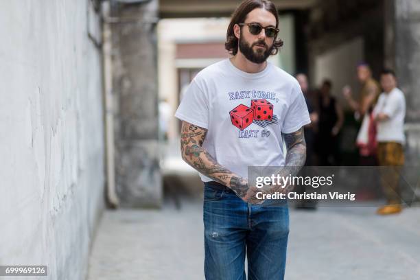 Guest wearing a tshirt with the print easy come easy go outside Boris Bidjan Saberi during Paris Fashion Week - Menswear Spring/Summer 2018 on June...