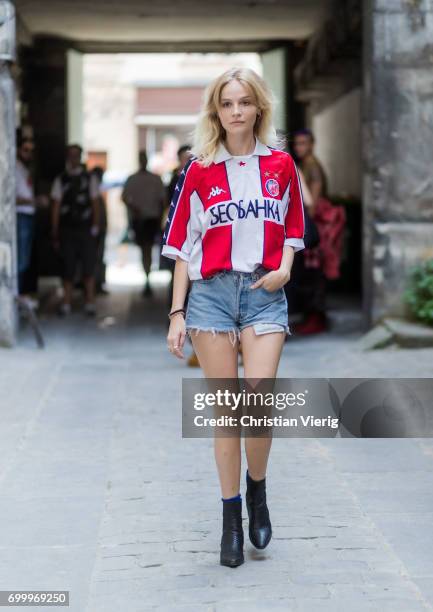 Guest wearing denim shorts and a football jersey outside Boris Bidjan Saberi during Paris Fashion Week - Menswear Spring/Summer 2018 on June 22, 2017...