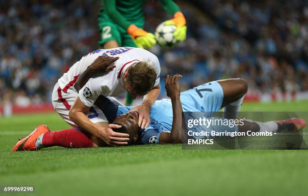 Manchester City's Kelechi Iheanacho receives help from Steaua Bucharest's Bogdan Mitrea after going down injured