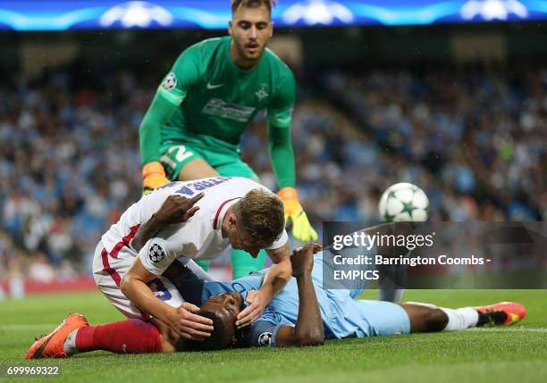 Manchester City's Kelechi Iheanacho receives help from Steaua Bucharest's Bogdan Mitrea after going down injured