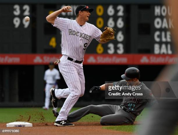 Colorado Rockies second baseman DJ LeMahieu loses the grip on the ball and can't complete the double play to first, but does get Jeremy Hazelbaker,...