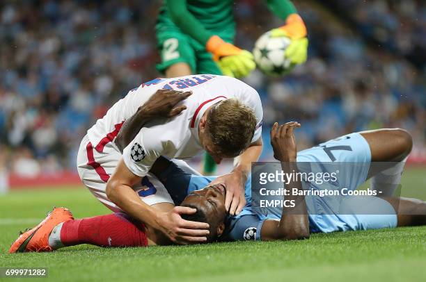 Manchester City's Kelechi Iheanacho receives help from Steaua Bucharest's Bogdan Mitrea after going down injured