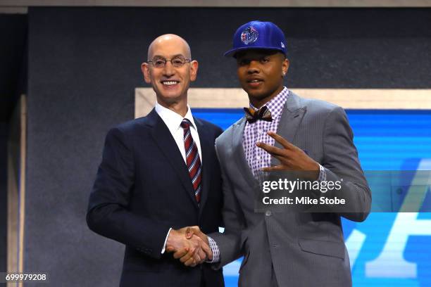 Markelle Fultz walks on stage with NBA commissioner Adam Silver after being drafted first overall by the Philadelphia 76ers during the first round of...