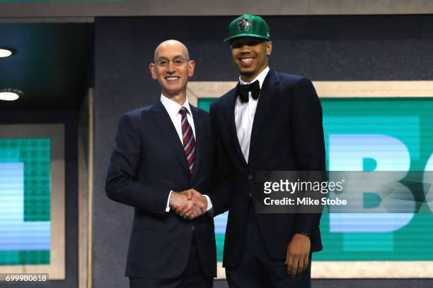 Jayson Tatum walks on stage with NBA commissioner Adam Silver after being drafted third overall by the Boston Celticsduring the first round of the...