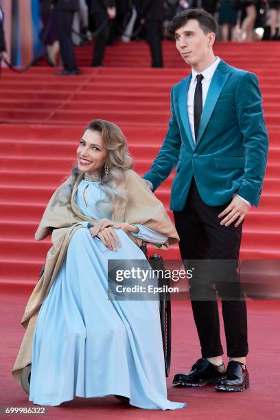 Russian singer Yulia Samoylova and her husband, musician Alexey Taran attend opening of the 39th Moscow International Film Festival outside the Karo...