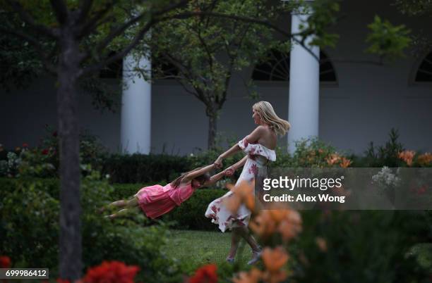 Ivanka Trump , daughter and assistant to President Donald Trump, plays with her daughter Arabella Rose Kushner in the Rose Garden during during a...