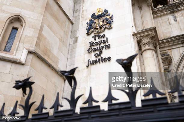 The Royal coat of arms and signage pictured on external wall of the Royal Courts Of Justice on the Strand in central London on June 16, 2017 in...
