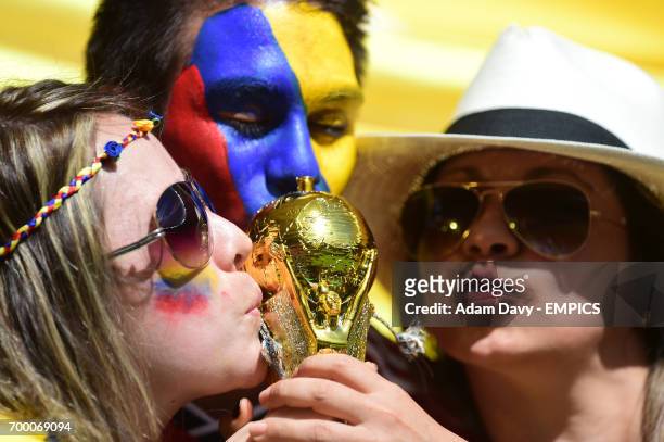 Columbia fans kiss a replica world cup trophy before kick off