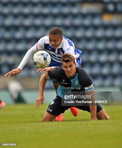 Wycombe Wanderers's Captain Matt Bloomfield and Reading's Michael Hector challenge for the ball