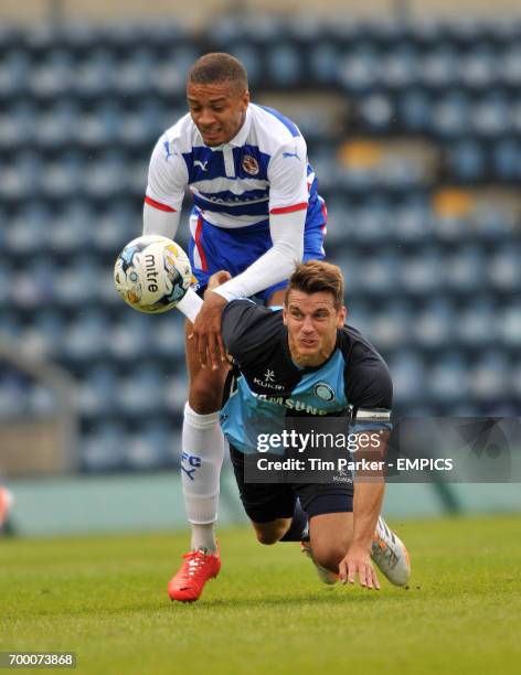 Wycombe Wanderers's Captain Matt Bloomfield and Reading's Michael Hector challenge for the ball