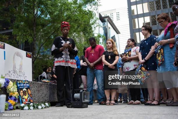 Demonstrators participate in a moment of silence during a candlelight vigil for Nabra Hassanen and other victims of hate crimes and state violence...