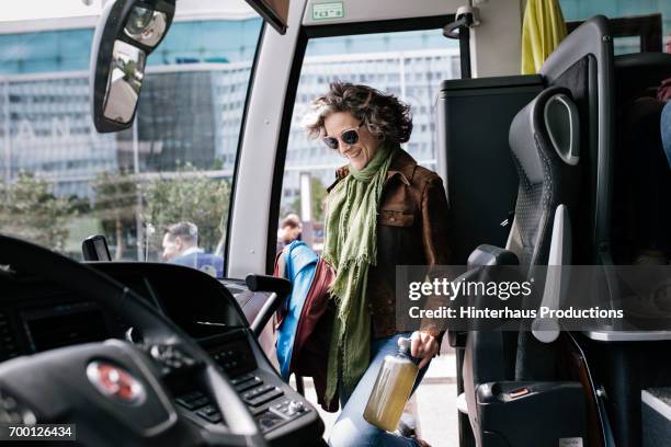 mature traveler boarding a bus - coach bus 個照片及圖片檔