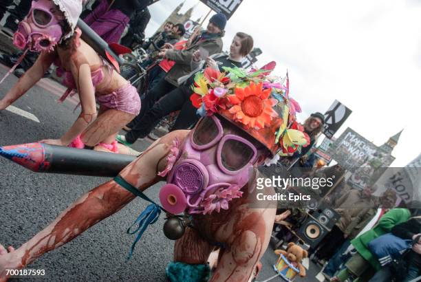 Anti-war protesters wearing pink gas masks protest in central London ahead of the 5th anniversary of the Iraq war during a worldwide day of protest...