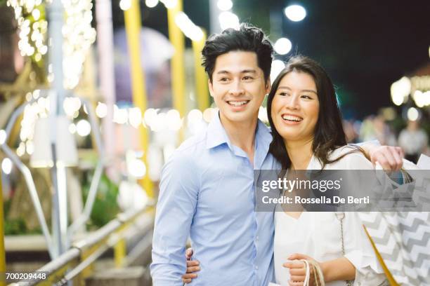 young asian couple enjoying shopping in the night market - bangkok shopping stock pictures, royalty-free photos & images