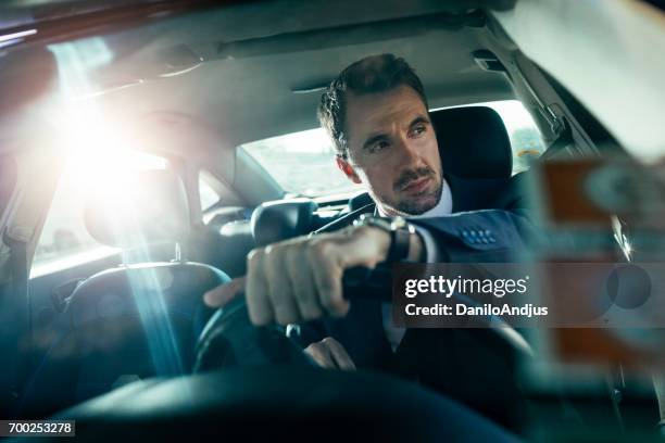 knappe man rijdende auto - business person driving stockfoto's en -beelden