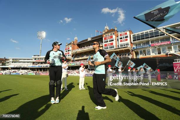 Surrey's Gary Wilson and Jade Dernbach make their way through the guard of honour before the game