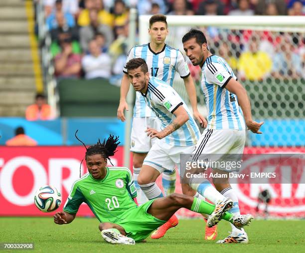 Nigeria's Michael Uchebo and Argentina's Ricky Alvarez battle for the ball