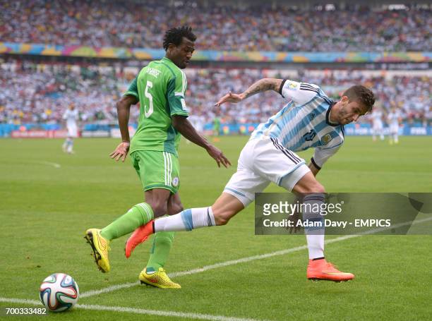 Nigeria's Efe Ambrose and Argentina's Ricardo Alvarez battle for the ball