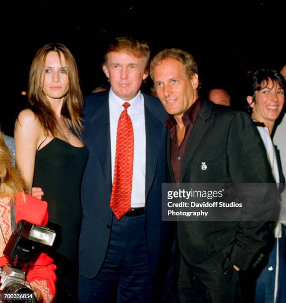 View of former model Melania Knauss and her boyfriend real estate developer Donald Trump as they pose with musician Michael Bolton at the Mar-a-Lago...