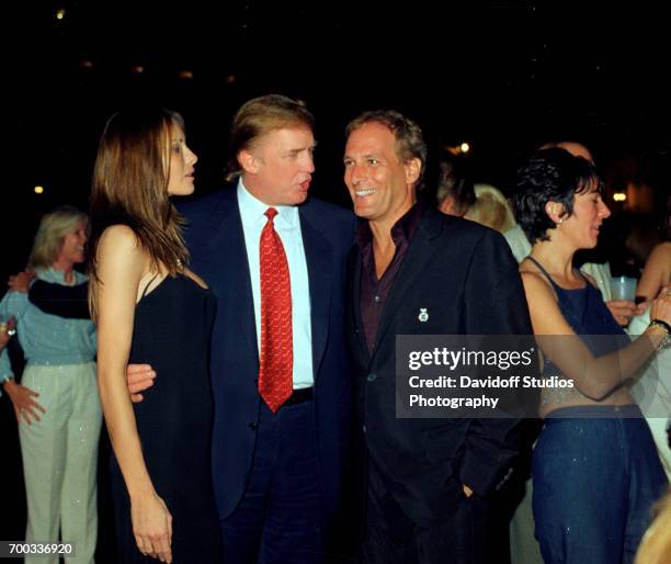 View of former model Melania Knauss and her boyfriend real estate developer Donald Trump as they talk with musician Michael Bolton at the Mar-a-Lago...