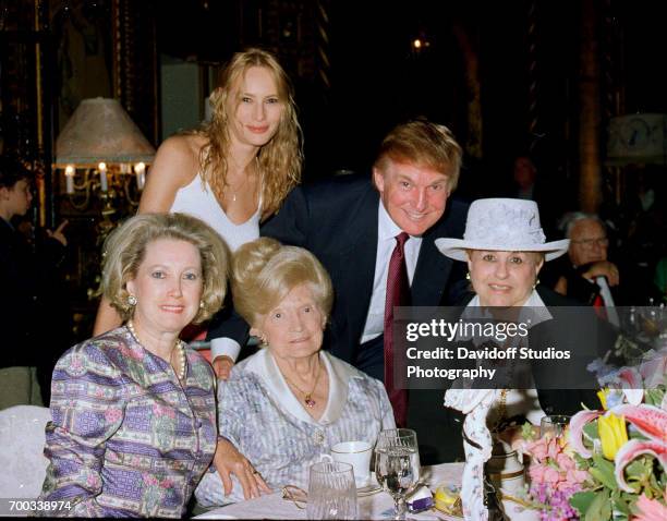 Portrait of members the Trump family as pose together at the Mar-a-Lago club, Palm Beach, Florida, circa 2000. Picture are, standing, former model...