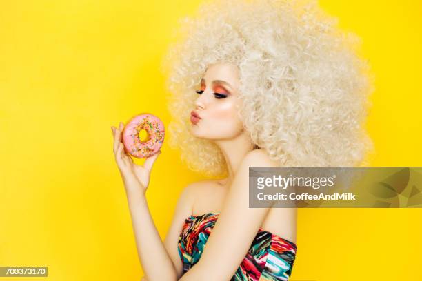 pretty blonde with pink donuts - fashion food stock pictures, royalty-free photos & images
