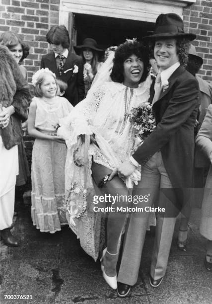 English singer Linda Lewis with guitarist Jim Cregan at their wedding at the church of St Barnabas in East Molesey, Surrey, 18th March 1977.