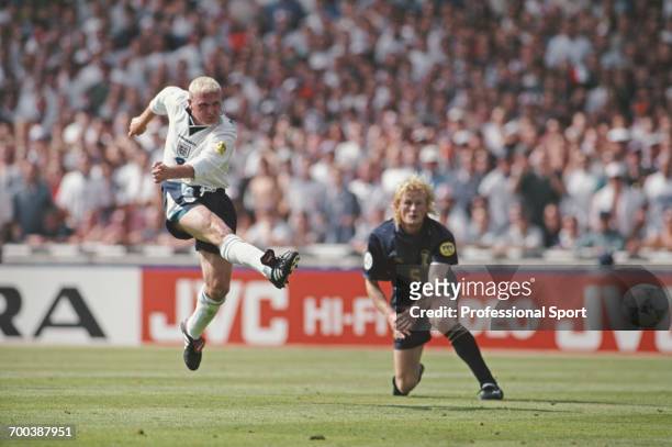 English footballer Paul Gascoigne scores England's second goal as Colin Hendry of Scotland looks on during the England v Scotland match in Group A of...