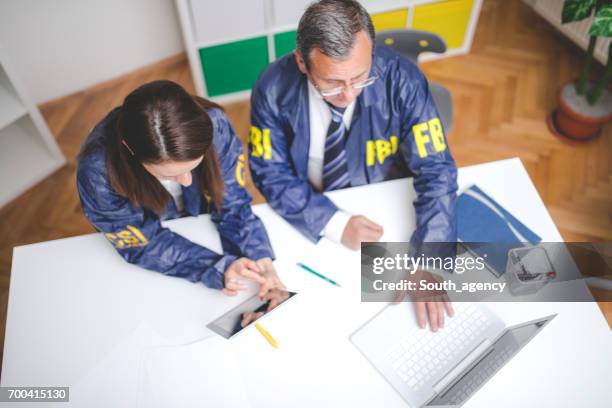 solving a new case - female fbi stock pictures, royalty-free photos & images