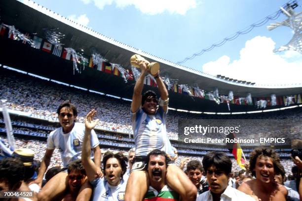 Argentina captain Diego Maradona holds the World Cup trophy aloft.