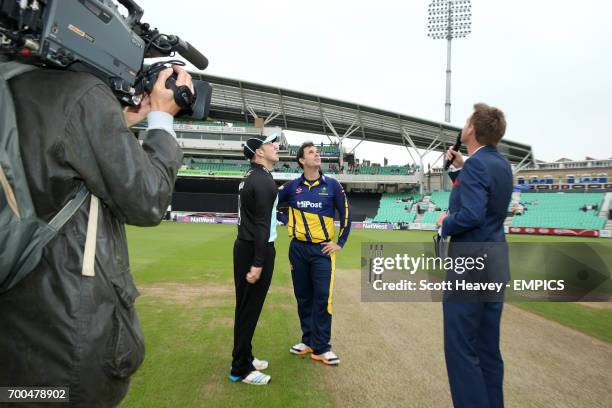 Surrey's Gary Wilson and Glamorgan's Mark Wallace are filmed by a television cameraman during the toss before the match