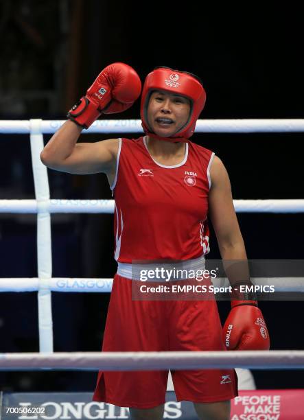 India's Laishram Devi celebrates her win against Mozambique's Maria Machongua in the Women's Light Semi-final 2 at the SECC, during the 2014...