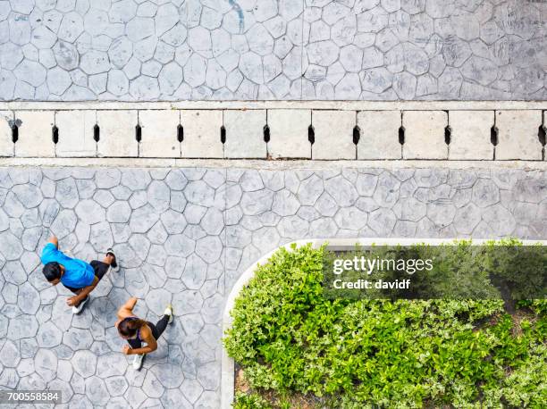 view looking down on jogging couple - people above park stock pictures, royalty-free photos & images
