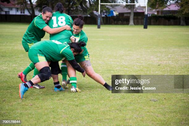 female rugby players tackling in action - rugby league women stock pictures, royalty-free photos & images