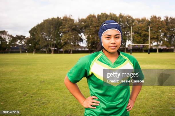 portrait of female rugby player looking into lens outside on rugby field - grittywomantrend stock pictures, royalty-free photos & images