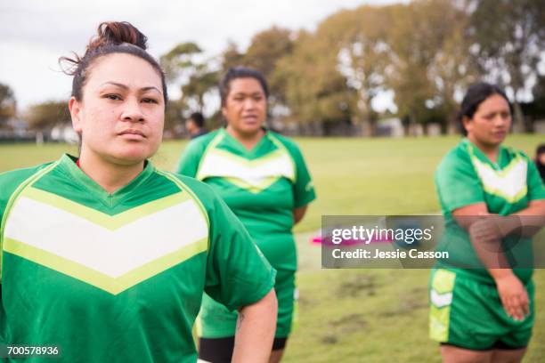 female rugby players stand watching the game - female rugby new zealand stock pictures, royalty-free photos & images