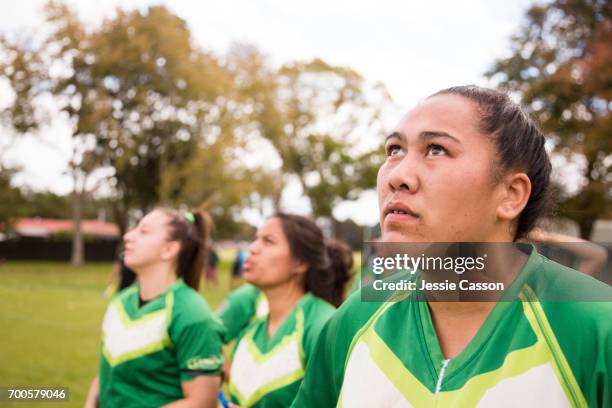female rugby players stand on field looking up - grittywomantrend stock pictures, royalty-free photos & images