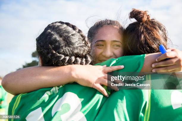 three female sports players embrace - rugby union team fotografías e imágenes de stock