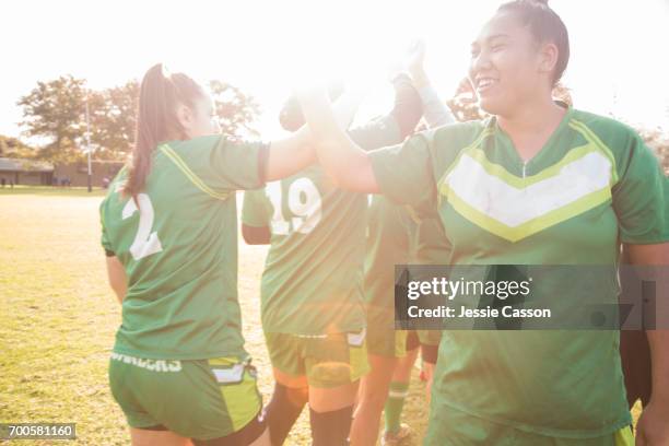 female rugby players on field celebrating after match - grittywomantrend stock pictures, royalty-free photos & images