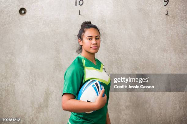 female rugby player in changing rooms holding ball - rugby - fotografias e filmes do acervo