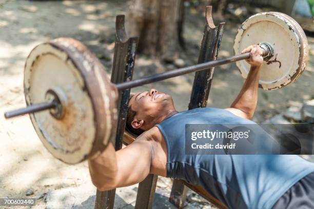 asian man lifting weights at a makeshift outdoor gym - makeshift gym stock pictures, royalty-free photos & images