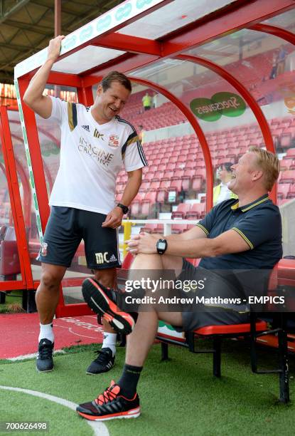 Southampton manager Ronald Koeman shares a joke with Swindon Town manager Mark Cooper before the pre-season friendly match at The County Ground,...