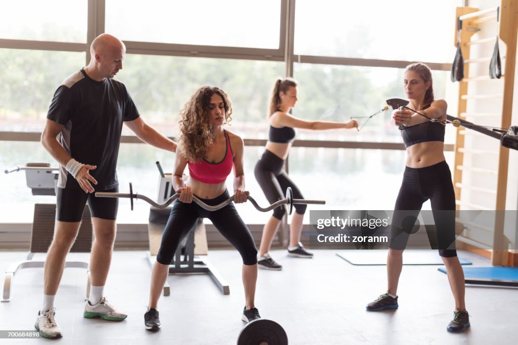 Trainer working with women in gym