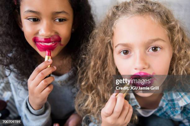 girls applying messy lipstick - friend mischief stock pictures, royalty-free photos & images