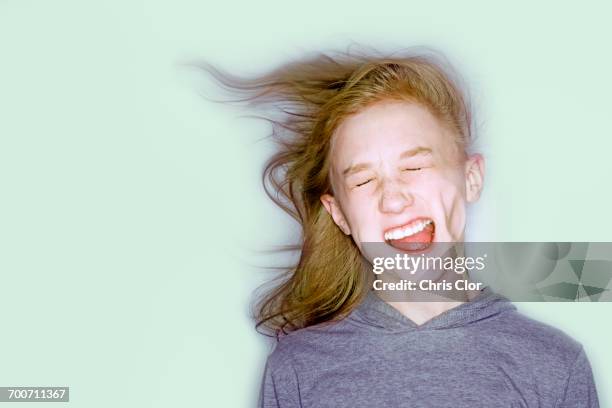 wind blowing face of caucasian girl - wind in face stock pictures, royalty-free photos & images