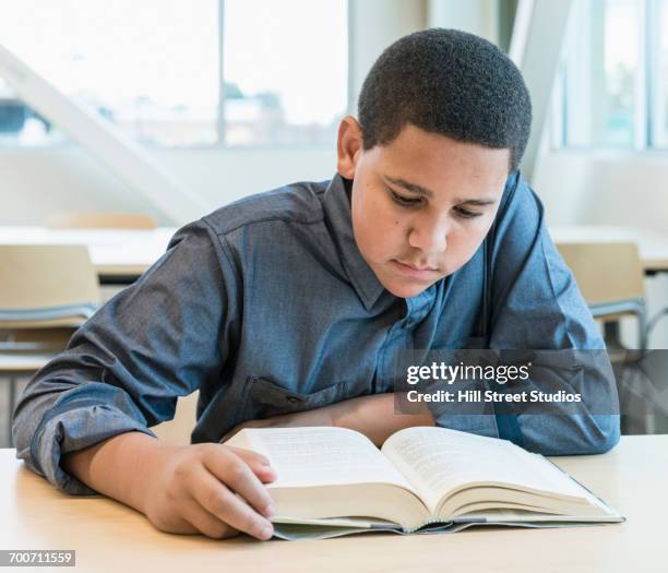 teenage boy reading book - teenager reading a book stock pictures, royalty-free photos & images