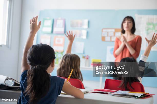 girls raising hand for teacher in classroom - asian kid raising hand bildbanksfoton och bilder