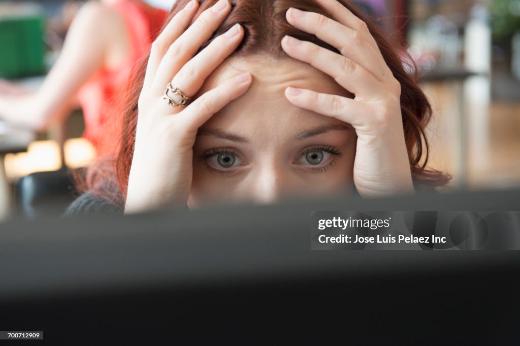 Frustrated Caucasian businesswoman using computer