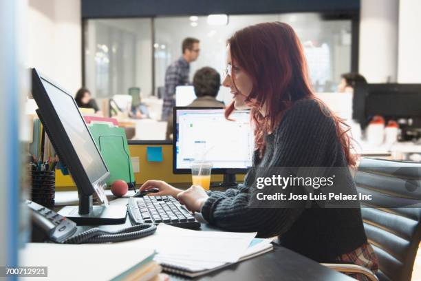 businesswoman using computer in office - west new york new jersey stock-fotos und bilder